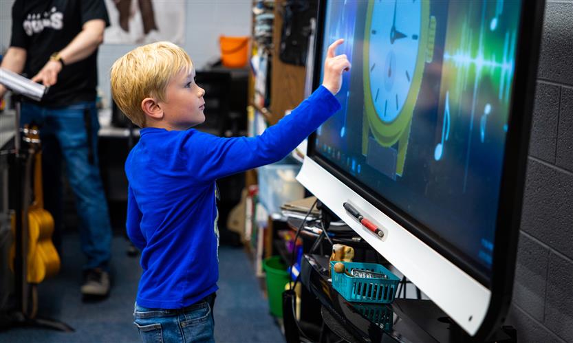 A student uses a Smart Board